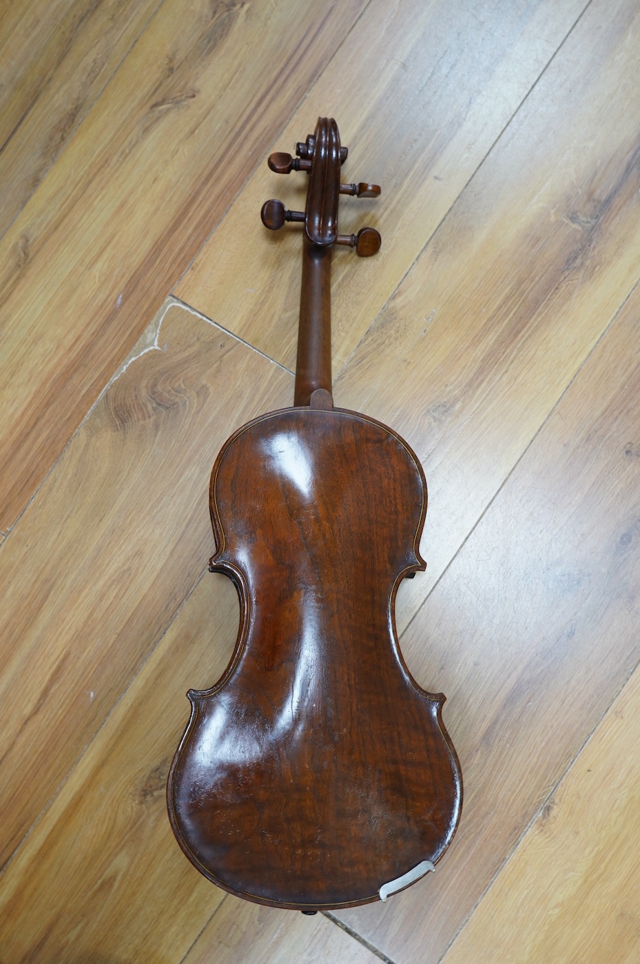 An early 20th century cased Welsh violin, the handwritten label inside the body reads; ‘James Parkinson, Llandudno No.9, 1921’, with a single piece back, inlaid stringing to the edge of the body, length of body 35.5cm, t